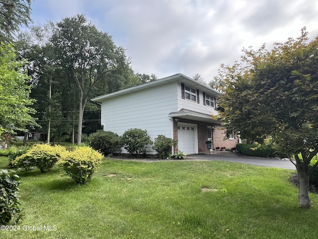 exterior space featuring a garage and a front lawn