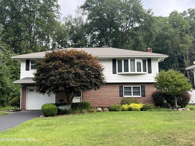 view of front of home with a garage and a front yard