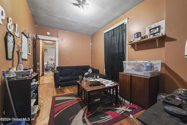 living area with a textured ceiling and wood finished floors