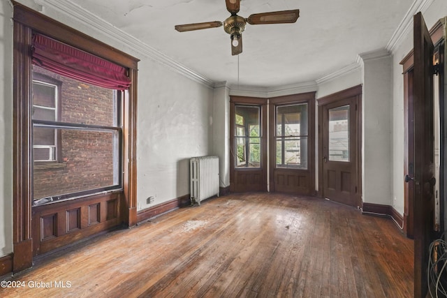 entryway with ornamental molding, radiator, baseboards, and hardwood / wood-style flooring