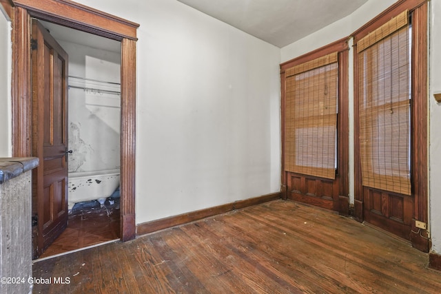 unfurnished bedroom featuring wood-type flooring and baseboards