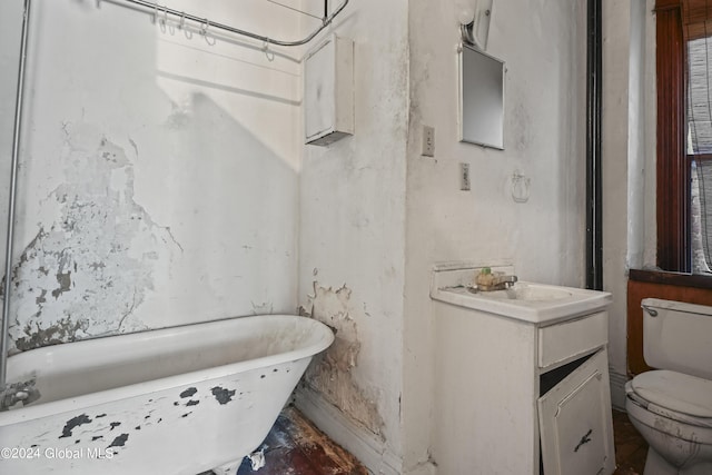 full bath with a soaking tub, vanity, and toilet