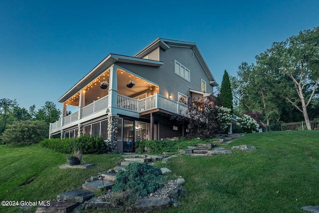 back of house featuring a yard