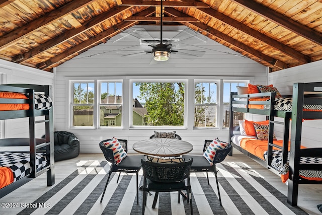 sunroom / solarium with ceiling fan, wooden ceiling, and lofted ceiling with beams