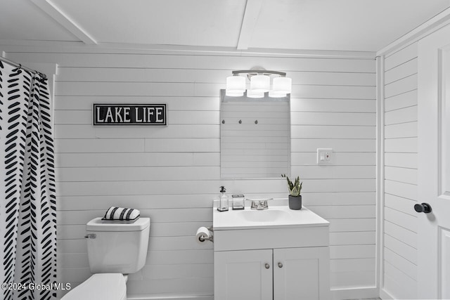 bathroom featuring toilet, wooden walls, walk in shower, and vanity