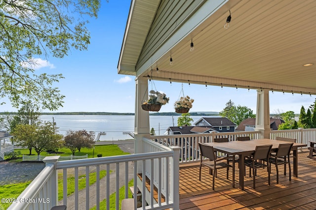 wooden terrace featuring a water view