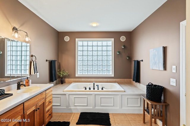 bathroom with plenty of natural light, tile patterned flooring, and a bathtub