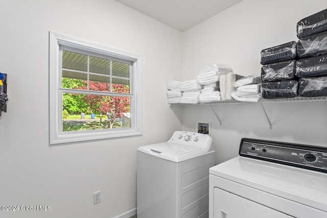 clothes washing area featuring washing machine and clothes dryer