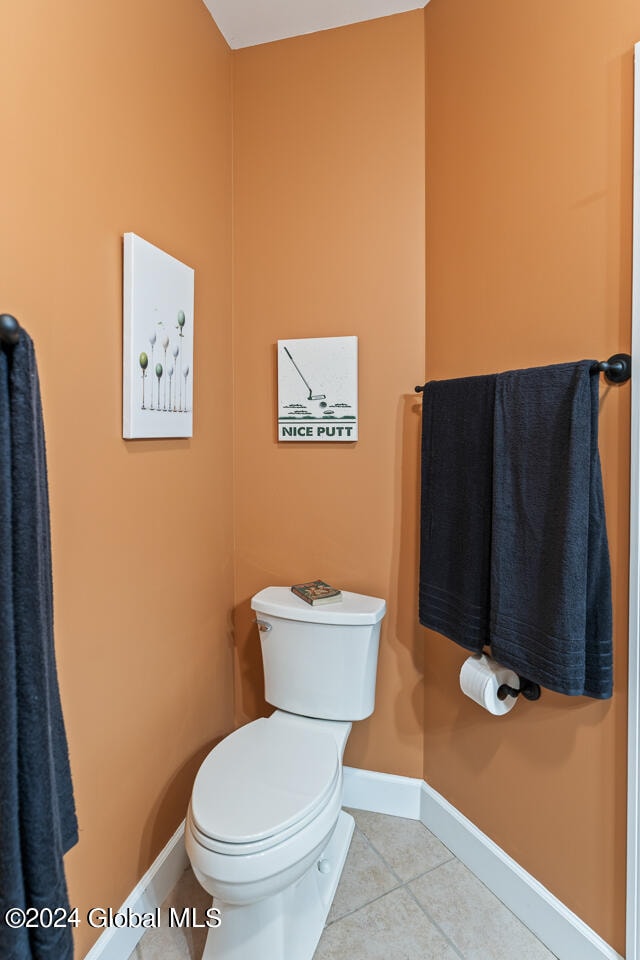 bathroom with toilet and tile patterned flooring