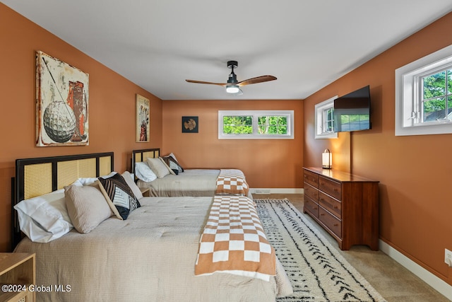 bedroom featuring light carpet and ceiling fan