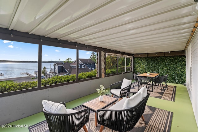 sunroom featuring a water view and plenty of natural light