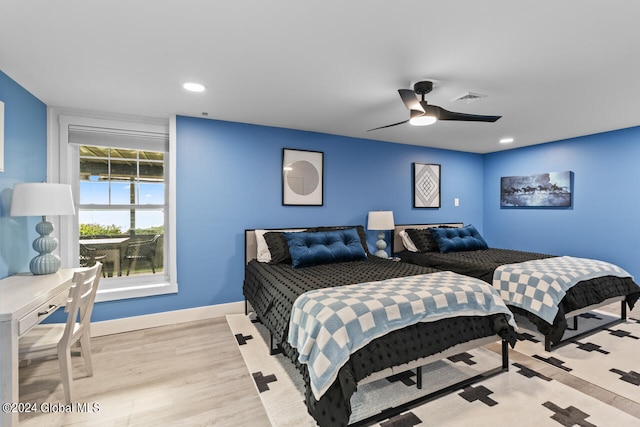 bedroom featuring ceiling fan and light hardwood / wood-style flooring