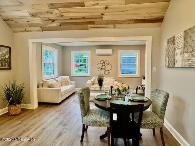 26 N 2nd Ave, Broadalbin, NY 12025 - dining area with a wall unit AC, wood finished floors, and wooden ceiling