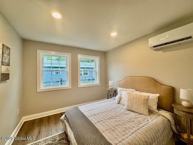 26 N 2nd Ave, Broadalbin, NY 12025 - bedroom featuring a wall mounted AC, wood finished floors, and recessed lighting