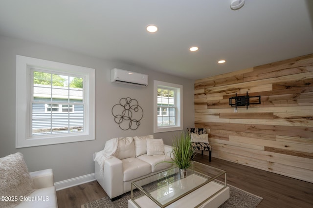 26 N 2nd Ave, Broadalbin, NY 12025 - living room with a wall unit AC, wood walls, recessed lighting, plenty of natural light, and wood finished floors