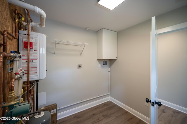 26 N 2nd Ave, Broadalbin, NY 12025 - laundry room with water heater, electric dryer hookup, dark wood-style floors, and cabinet space