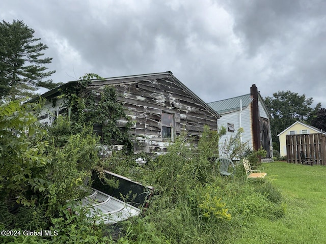 view of property exterior with a lawn