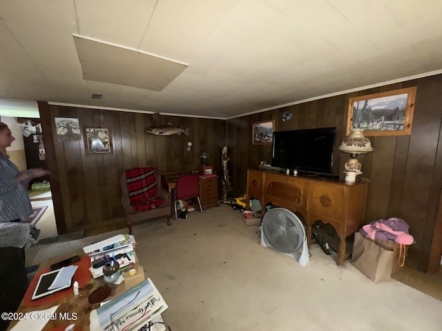 living room featuring wood walls and concrete flooring