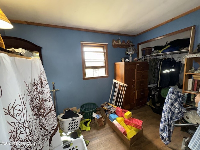 interior space featuring hardwood / wood-style flooring, a closet, and crown molding