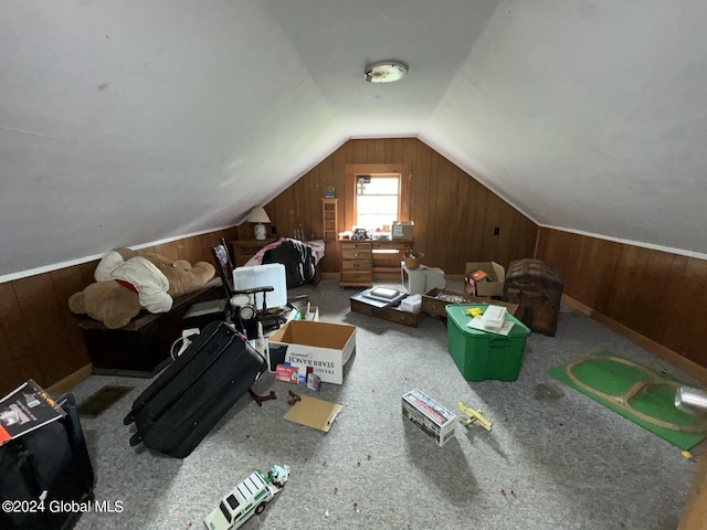 bonus room featuring carpet flooring, wood walls, and lofted ceiling