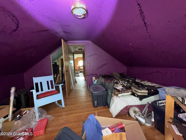 additional living space featuring light hardwood / wood-style flooring and lofted ceiling