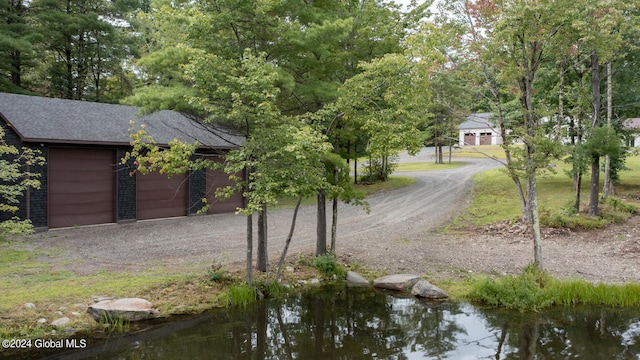 view of front facade featuring a water view and a garage