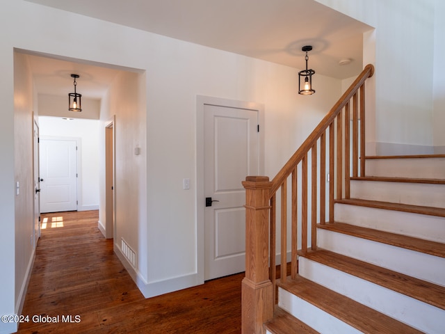 stairway with hardwood / wood-style flooring