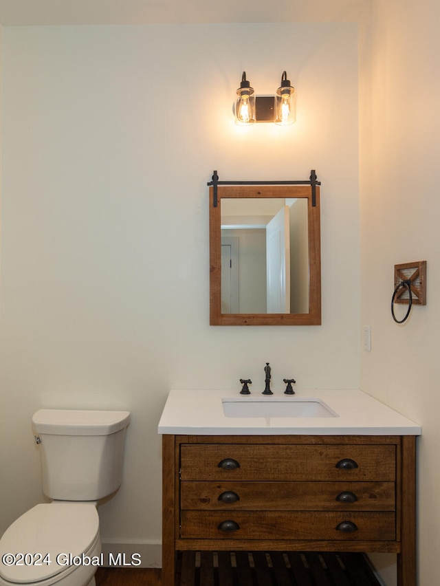 bathroom featuring vanity and toilet