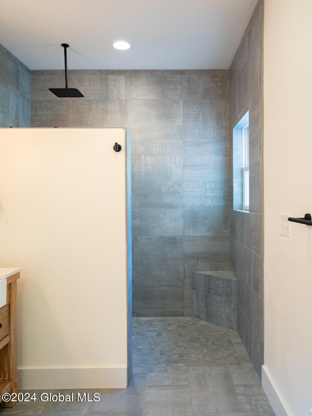 bathroom featuring vanity and tiled shower