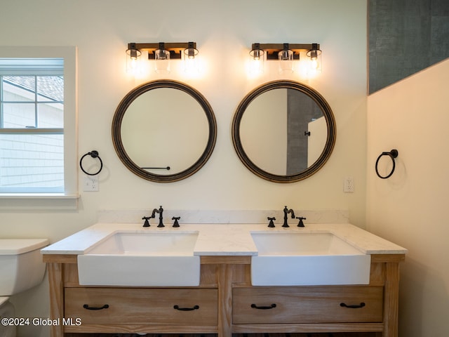 bathroom featuring vanity and toilet