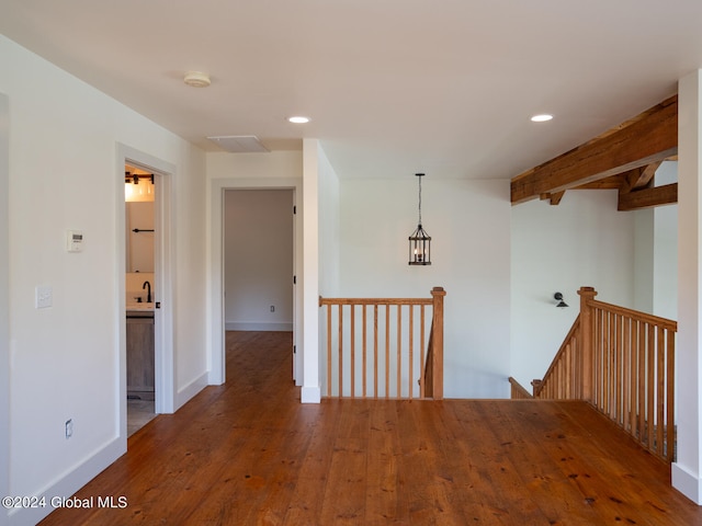 hallway featuring hardwood / wood-style flooring and sink