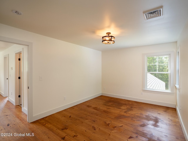 spare room with hardwood / wood-style floors