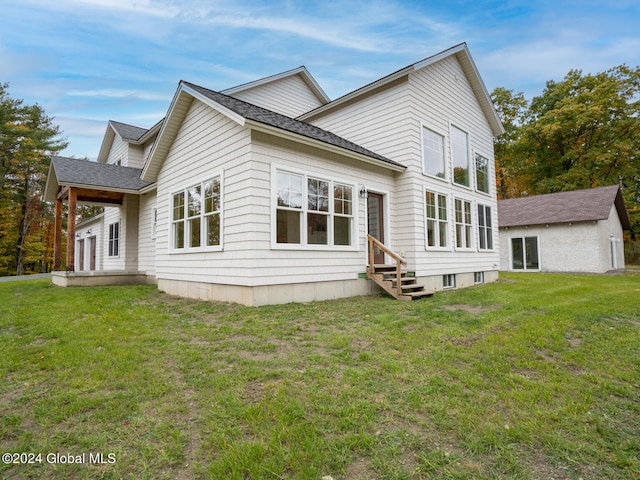 rear view of house with a yard