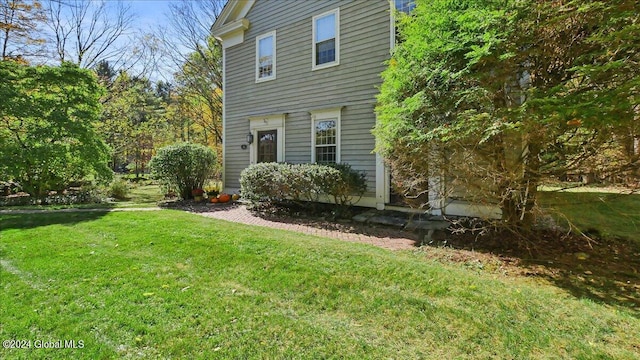 view of home's exterior with a lawn