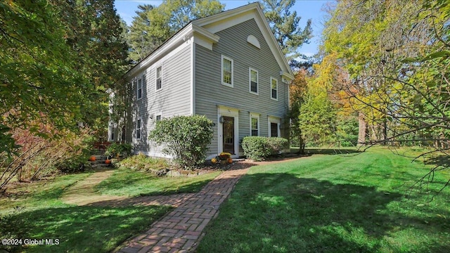 view of side of property with a lawn