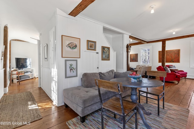 living room with wood-type flooring and beamed ceiling