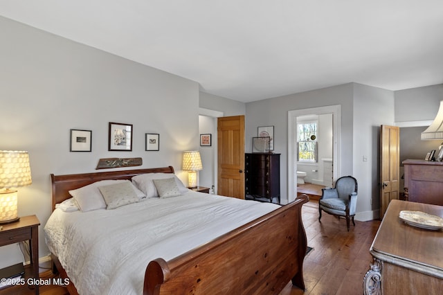 bedroom with hardwood / wood-style flooring, baseboards, and ensuite bathroom