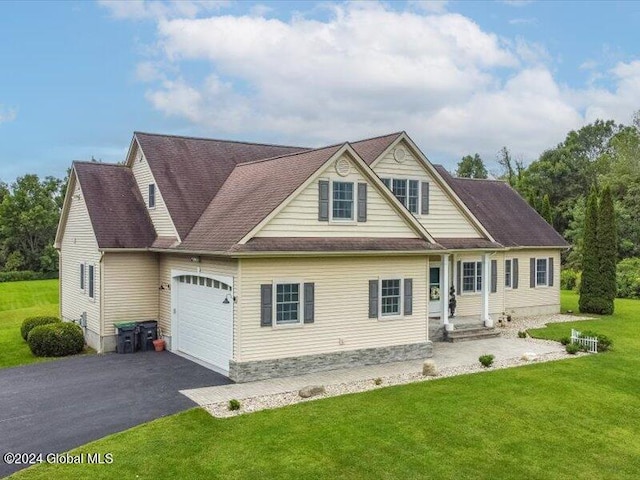 view of front of house featuring a garage and a front lawn