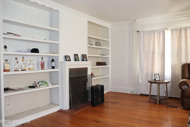 living room with dark hardwood / wood-style flooring and ornamental molding