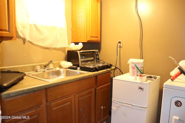 kitchen with washer / dryer and sink