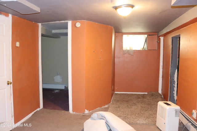 hallway with a baseboard radiator and carpet flooring