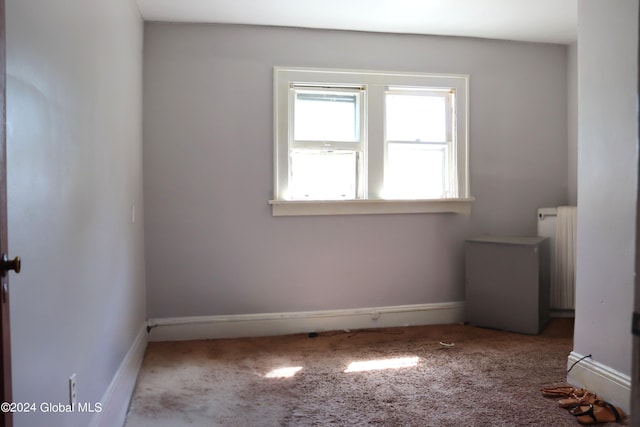 interior space featuring carpet flooring and radiator