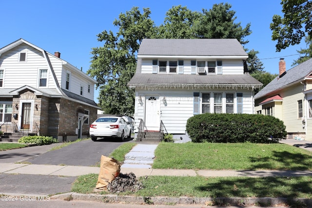 view of front of house with a garage and a front yard