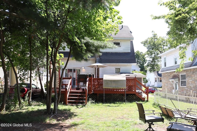 back of house featuring a yard and a deck