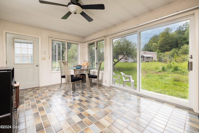 sunroom featuring ceiling fan