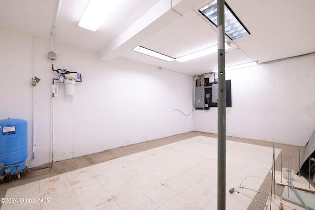 basement with tile patterned floors and electric panel