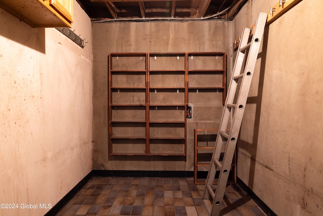 basement featuring dark tile patterned flooring