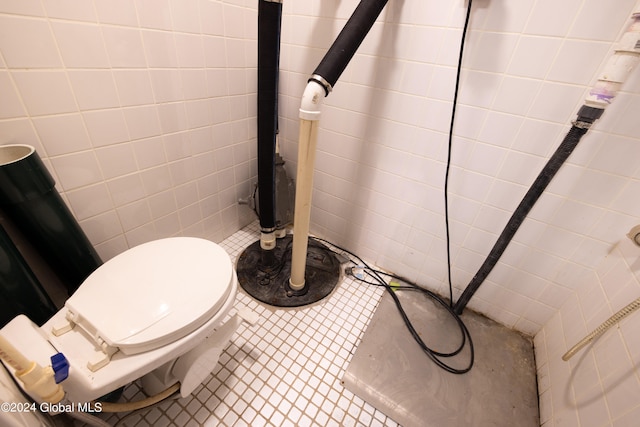 bathroom featuring tile walls, toilet, and tile patterned floors