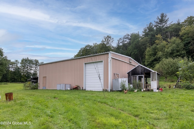 view of outbuilding featuring a garage and a lawn