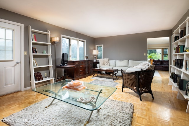 living room with plenty of natural light and light parquet floors